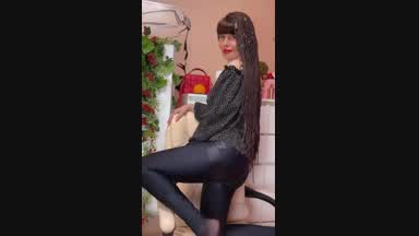 In a dark blouse and leggings