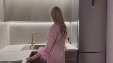 Naked body in the kitchen in a bathrobe