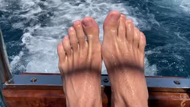 Male feet in water stream