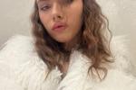 In a white fur coat