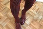 red fishnets over black tights and burgundy brogue