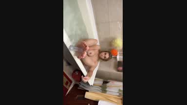 Feet play with dildo in bath