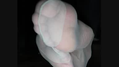 Light grey nylon feet from underneath my desk whil