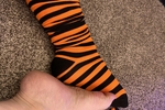 Orange striped socks for sale, worn by model