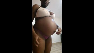 42 weeks pregnant, naked playing with belly button