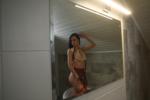 Dressed cam girl in student outfit taking shower