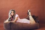 tenderness in a pink dress on a cozy sofa