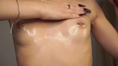 Oiled nipples closer to camera