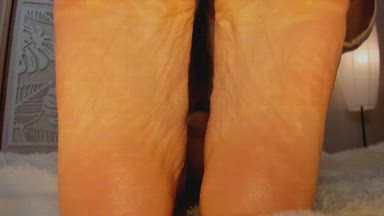 Oiled soles pointing to your face