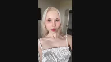 Dancing in the mirror in a white outfit