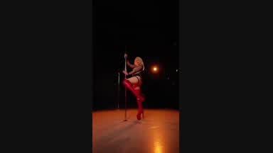 Pole dancing in red thigh-high boots