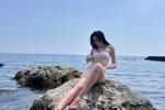 Tiny swimsuit in the rocks and sea
