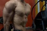 flexing muscles intensely at the gym