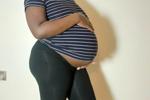 42 weeks pregnant side view in a shirt and shorts