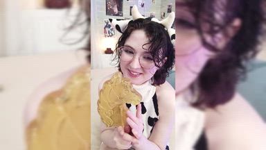 a cow girl sucking a huge lollipop