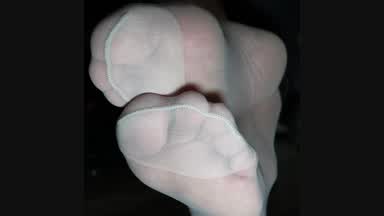 Light grey nylon feet from underneath my desk whil
