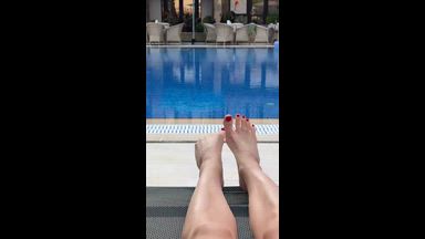 Red toenails on pool