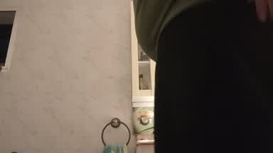 in the bathroom showing ass